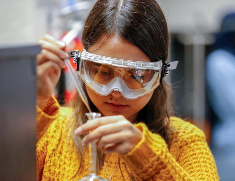 Student in a lab wearing goggles